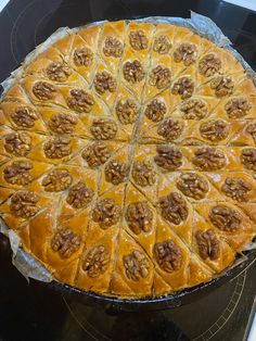 a pie sitting on top of a stove covered in toppings