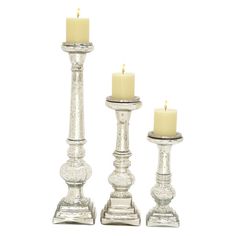 three glass candlesticks are sitting next to each other