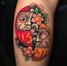 a close up of a person's leg with a tattoo on it and flowers