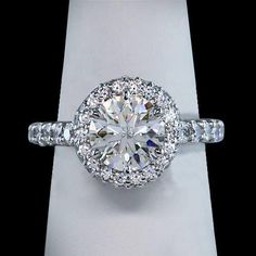 a diamond ring with two rows of diamonds around it on top of a white box