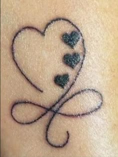 a heart tattoo on the back of a woman's arm with three hearts in it