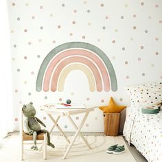 a child's room with polka dot wallpaper and a rainbow painted on the wall