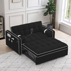 a black futon bed sitting on top of a white rug in a living room