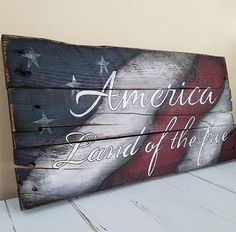 a wooden sign with an american flag painted on it