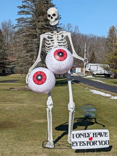 a skeleton holding two balls in the shape of an eyeball with a sign that says i only have eyes for you