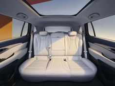 the interior of a vehicle with white leather seats and sunroofing area on top