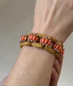 Exquisite 18k gold vintage 1960s bracelet, set with coral and approx. 3.00ctw VS-SI1/H diamonds. DESIGNER: Not Signed MATERIAL: 18k Gold GEMSTONES: Diamond, Coral DIMENSIONS: Bracelet is 6.75" long and 22mm wide. MARKED/TESTED: 18k, E65. WEIGHT: 86.2 grams CONDITION: Previously Owned/Excellent Condition Vintage Gold Bangles, Coral Gold Jewellery, Bangle Models, 1960s Bracelet, Ruby Jewelry Ring, Vintage Diamond Bracelet, Bangle Bar, Coral Jewelry Vintage, Coral Jewellery