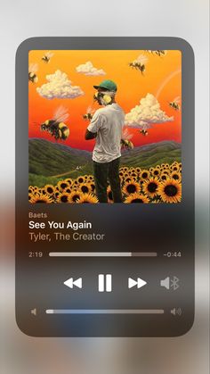 an mp3 player is shown with the music player on it's screen and sunflowers in the background