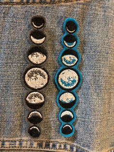 three different types of buttons in the back pocket of someone's jean jacket,