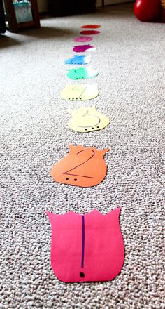 a row of cut out paper animals on the ground