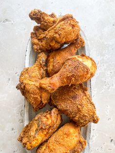 a basket filled with fried chicken on top of a table