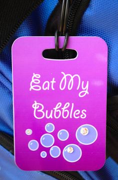 a purple tag that says eat my bubbles on it