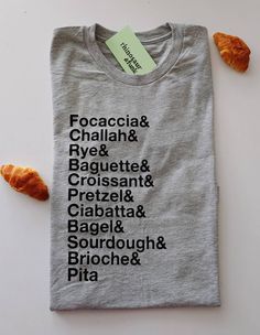 Nothing's better than a good bread bake. The shirts are soft and light - never scratchy! They are a cotton poly blend and have a fashion/slim fit. Design measures approximately 9-10 inches across. Each order is hand-printed by me <3 All designs can also be printed on any other t-shirt, tank, or sweater color that you see in the store Bread Baker, Cotton Shirts, Bread Baking, T Shirt Print, Colorful Hoodies, Favorite Shirts, Colorful Sweaters, Crew Neck Sweater, Cool Shirts