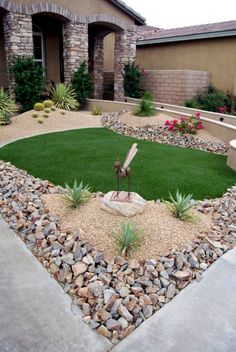 a small yard with grass and rocks in it