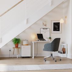 an office area with a desk, chair and stairs leading up to the second floor