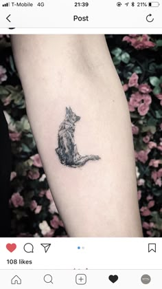 a small cat tattoo on the arm