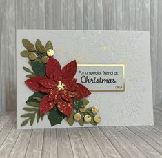 a christmas card with poinsettis and buttons