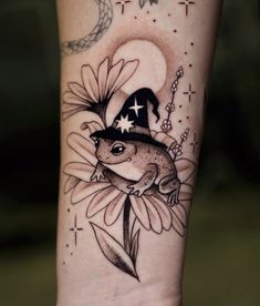 a tattoo with a frog wearing a witches hat