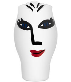 a white vase with black and red face painted on it's side, in the shape of a woman's head