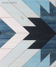 an arrow painted on wood with blue and white paint