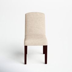 a beige chair sitting on top of a white floor