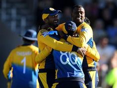 two men in yellow and blue uniforms hugging each other