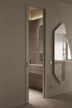 an open door leading to a bathroom with a mirror on the wall and sink in the background