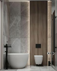 a white bath tub sitting next to a toilet in a bathroom under a wooden paneled wall