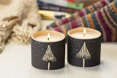 two candles sitting next to each other on a table