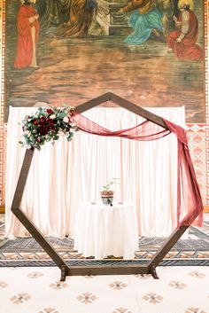 a table set up for a wedding in front of a painting