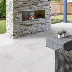 an outdoor fireplace in the middle of a patio