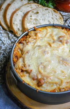 a casserole dish with bread on the side