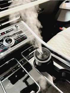 the interior of a car with steam coming out of the burner and control knobs