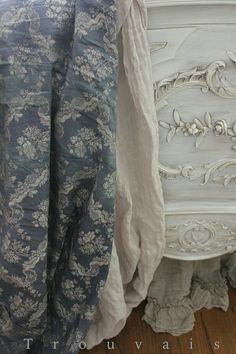 two white and blue bedspreads sitting next to each other