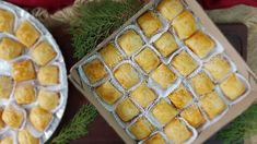 two trays filled with food sitting on top of a table next to each other