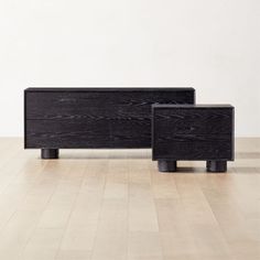 two black sideboards sitting on top of a hard wood floor next to each other