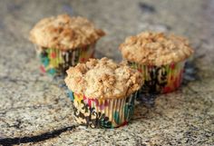 three muffins sitting on top of a granite countertop next to each other