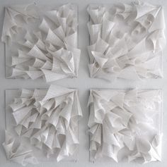 four pieces of art made out of white paper