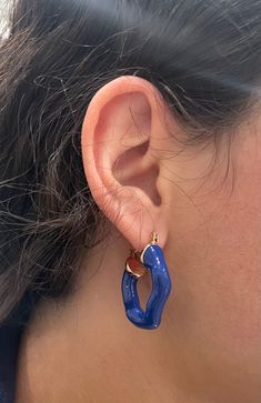 Amplify your earring collection with the Jarol Abstract Hoop. This unique stunner features a perfectly imperfect hoop in a beautiful royal blue. 1 1/2 " 18k plated with an enamel coating Made to last Water & tarnish resistant Trendy Enamel Hoop Jewelry, Blue Hypoallergenic Hoop Jewelry, Hypoallergenic Blue Hoop Jewelry, Blue Hypoallergenic Small Hoop Jewelry, Hypoallergenic Blue Small Hoop Jewelry, Blue Hypoallergenic Hoop Earrings, Bold Blue Drop Earrings, Modern Blue Hoop Jewelry, Trendy Nickel-free Blue Hoop Earrings