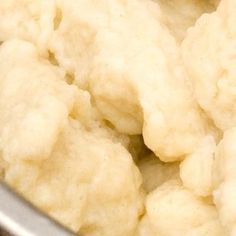 cauliflower is being cooked in a pot with a spatula