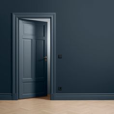 an open door in a dark room with parquet flooring and walls painted blue