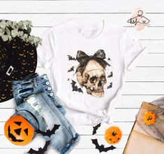 Skull Shirt, Halloween Skull Tee, Skull Coquette T-shirt, Halloween Gift, Halloween Season Shirt, Spooky Season Outfit, Halloween Bats Shirt Hello!! We wish everyone to smile with our cute, stylish, and trendy graphic shirts. We assure you these shirts are the perfect gifts whether you buy them for yourself or someone else. Please, check the size chart before you purchase. HOW TO MAKE AN ORDER *Pick your shirt type and size Your design will be printed on the front. *Pick your shirt color. PRODUCTION Processing time is 1-3 business days. For rush orders please contact us first. SHIPPING Domestic Shipping First Class 2-5 Business days Priority Mail 1-3 Business days Express Mail 1-2 Business days MATERIAL CARE Turn inside out. Cold Wash Do not bleach, dry clean, or iron directly onto the des Bat Shirt, Outfit Halloween, Skull Tee, Skull Shirt, Skull Shirts, Halloween Bats, Halloween T Shirt, Halloween Skull, Halloween Season