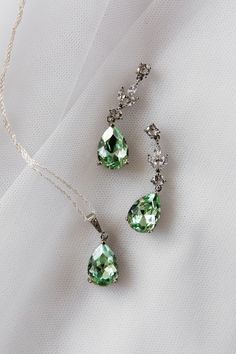 An absolutely stunning sage green / peridot colour teardrop jewellery set.  Simulated diamonds.  Standard 18 inch chain - other lengths available ie 16, 20 inch or add a 2 inch extension- please just add details to order notes otherwise standard 18 inch will be sent.  Earring length approx 1.5 inch.  Silver plated lead and nickel free. ( sterling silver chain )  Beautifully gift boxed Green Bridal Jewellery Set, Green Bridal Jewellery, Earring Pendant Set, Bridal Jewellery Set, Bridal Jewellery Inspiration, Teardrop Jewelry, Marquise Cut Engagement Ring, Formal Jewelry, Wedding Earrings Drop