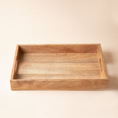 an empty wooden tray on a white wall