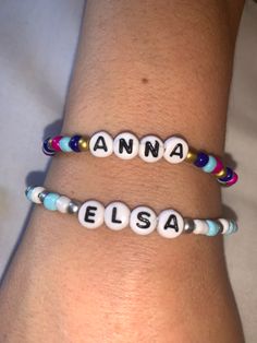 two personalized bracelets on someone's arm, one with name and bead