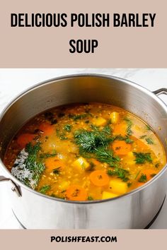 delicious polish barley soup with carrots and parsley in a silver pot on a white table