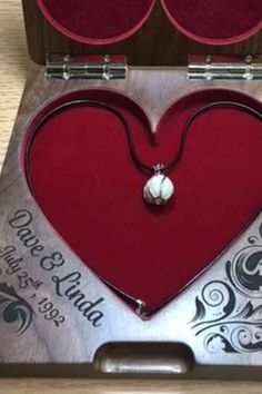 a red heart shaped box with two hearts in it