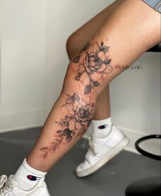 a woman's leg with flowers on it