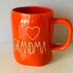 an orange coffee mug with i love grandma written on it