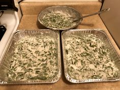 two pans filled with food sitting on top of a counter